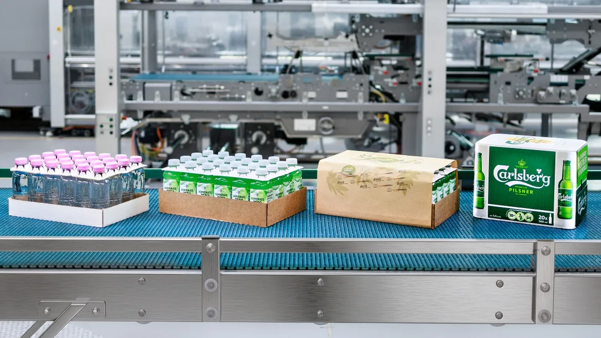 Packaged beverages moving along a conveyor in a packaging line.