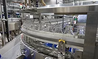 O-AT-KA bottles on conveyor