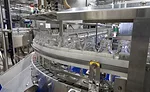 O-AT-KA bottles on conveyor