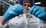Master cheesemaker Jeff LeBeau showcases a stick of string cheese. Baker Cheese uses traditional low-moisture/part-skim mozzarella cheesemaking procedures to get the best stretch and stringability.