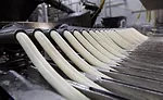 Baker Cheese’s products are formed into cheese tubes in one of nine extruders. They are then cut into individual string cheese pieces.    