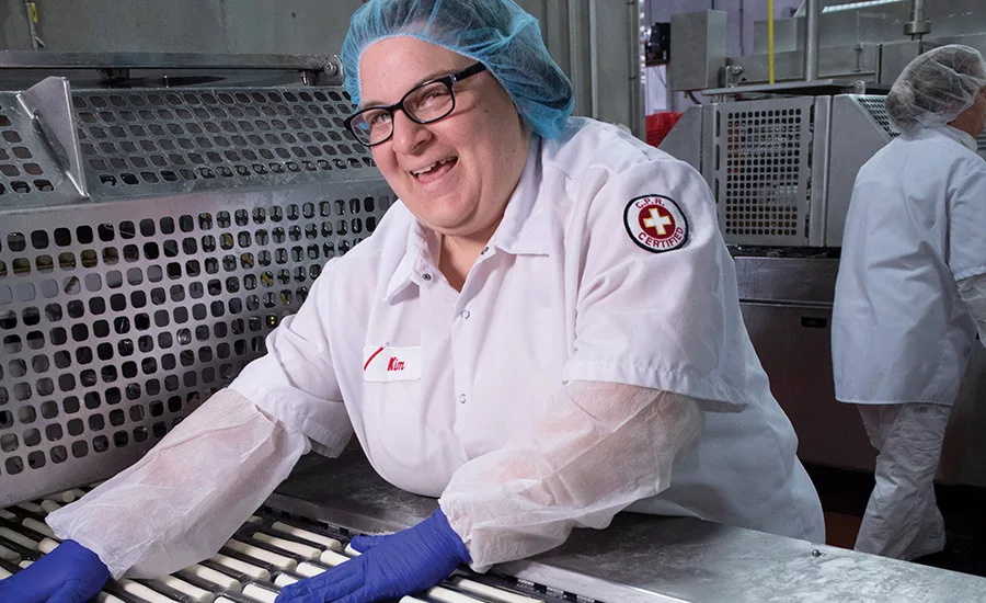 Packaging department employees fill in any cheese sticks that the automatic loaders may have missed.