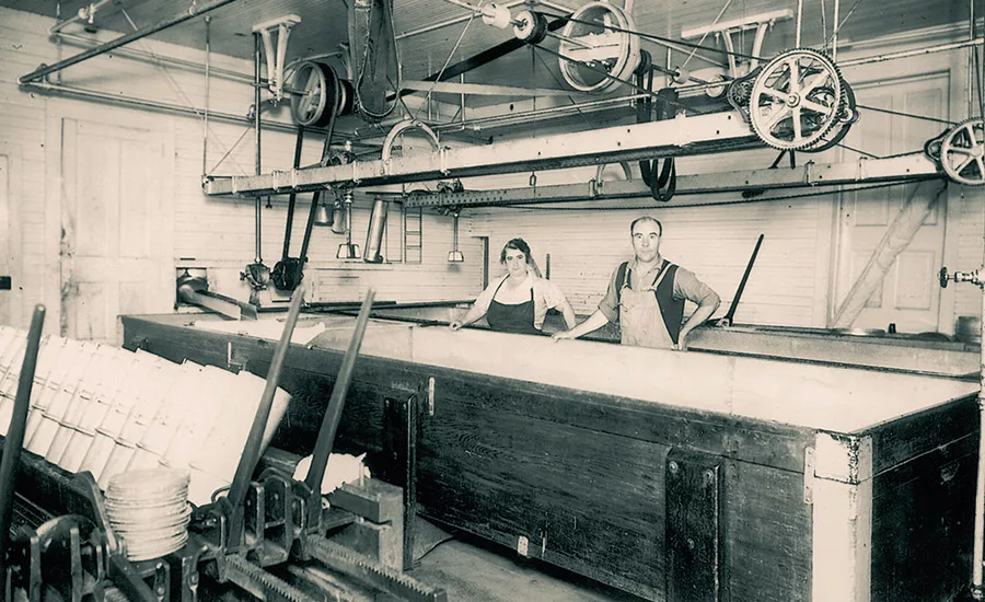 Frank Baker, founder of Baker Cheese, poses with his wife Marguerite in the Baker Cheese plant. Photo courtesy of Baker Cheese.