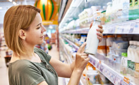 woman reviewing dairy products at the grocery store