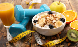 weights, healthy food and measuring tape