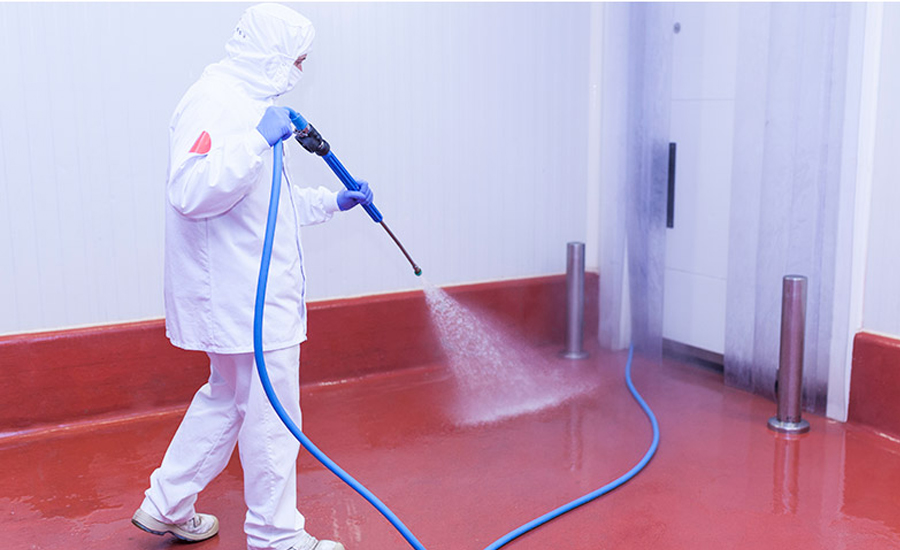 man sanitizing floor