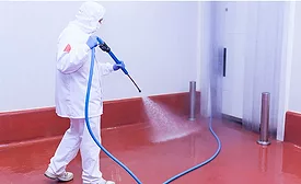 man sanitizing floor