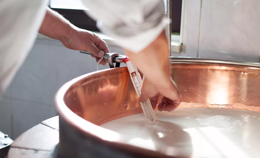 man making cheese