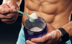 man taking a scoop of whey protein