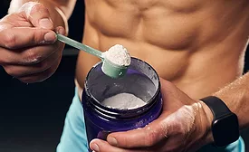 man taking a scoop of whey protein