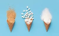 ice cream cones filled with brown sugar, white sugar and cubed sugar
