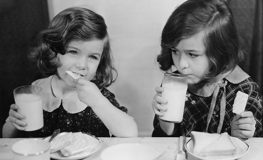 black and white images of two girls eating