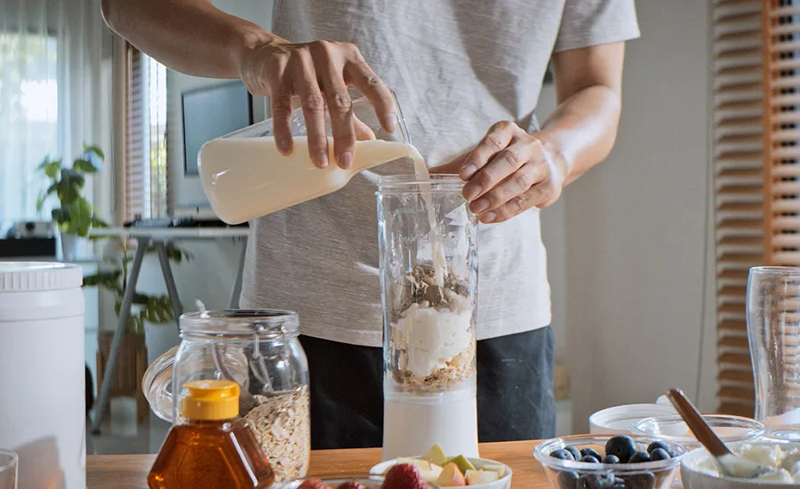 man making a smoothie