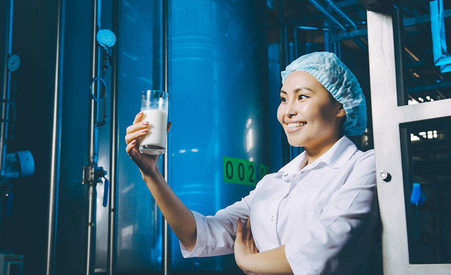 woman holding milk in the factory