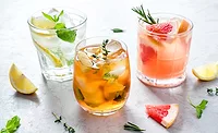 three refreshing drinks, likely variations of a spritz or similar cocktails