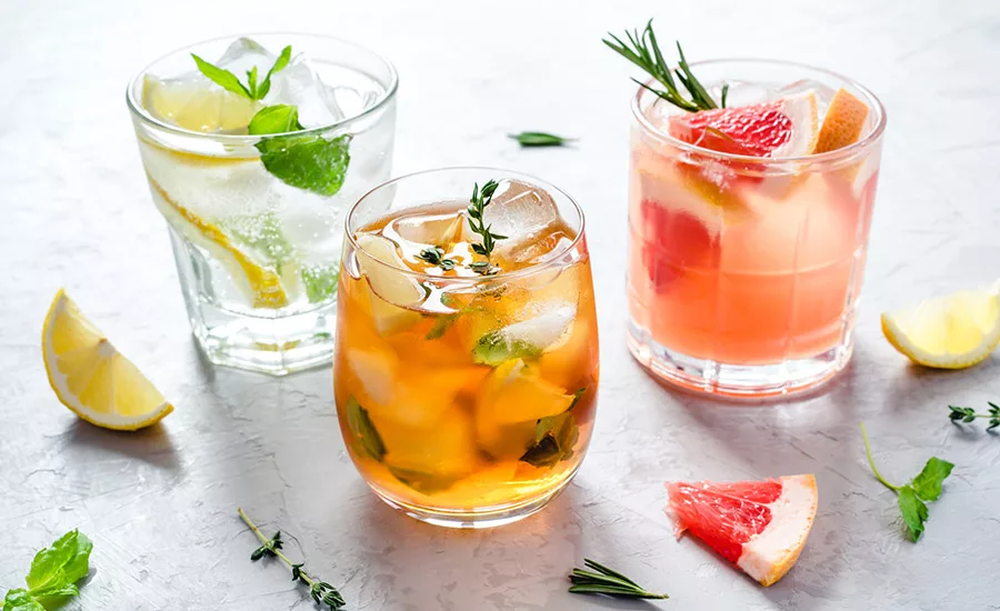 three refreshing drinks, likely variations of a spritz or similar cocktails