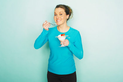 Woman eating yogurt FEATURE size