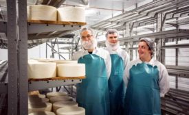 David Rogers, Dan Flavin and Alyssa Stone stand inside the Standard Market cheese cave