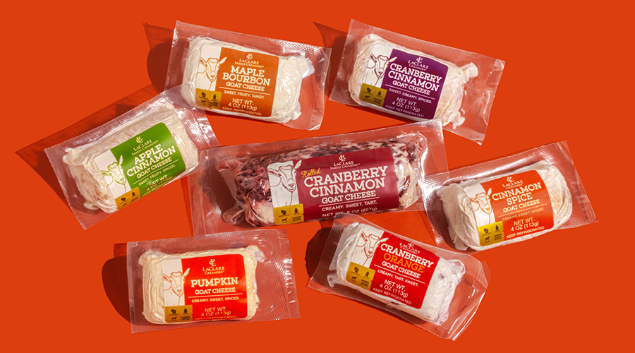 Group of LaClare Creamery’s Pumpkin Goat Cheese in a variety of flavors on an orange background.