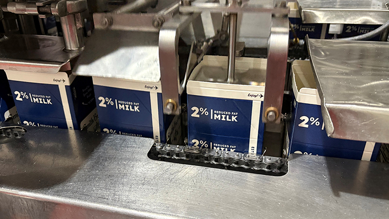 2% reduced fat milk cartons on a factory packaging line conveyor belt.