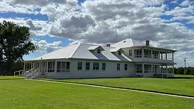 Exterior shot of Joseph Gallo Farms surrounded by grass and blue skies.