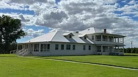 Exterior shot of Joseph Gallo Farms surrounded by grass and blue skies.