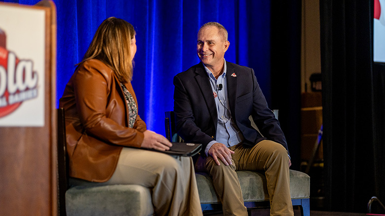 Maola Local Dairies CEO Jon Cowell sitting with a woman at one of the company's annual meetings.