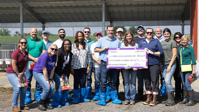 Maola staff accepting a check from sustainability partners, the Alliance for Chesapeake Bay