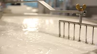 A vat of milk being mixed A vat of milk being mixed