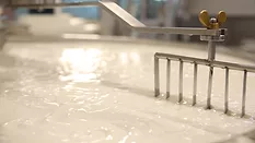 A vat of milk being mixed