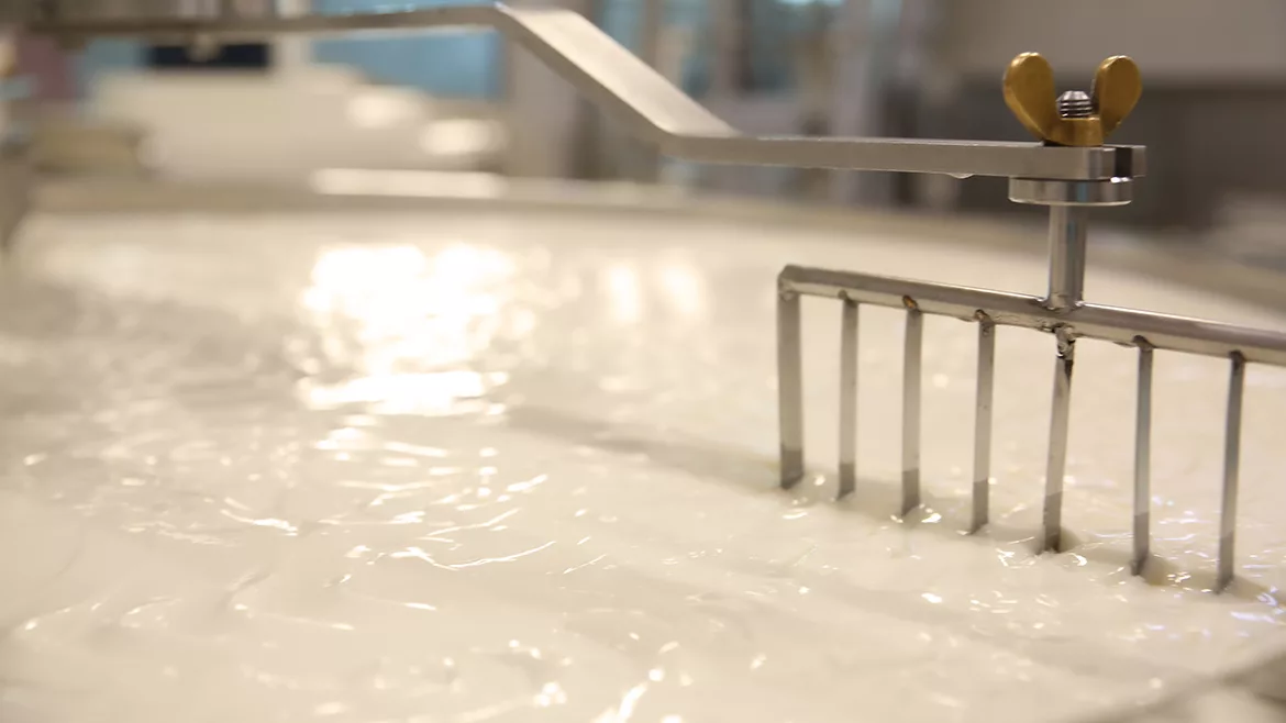 A vat of milk being mixed