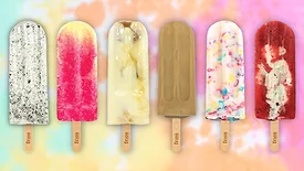 A row of Frios Gourmet Pops with a tie dye pattern as a background.