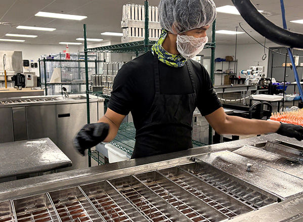 A Frios facility employee processing pops.