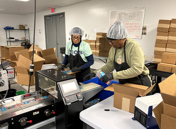 Two Frios workers packaging Frios Gourmet Pops to be sent to franchisees.