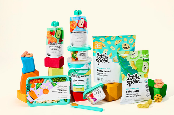 A variety of LIttle Spoon baby food products assembled together on a light background.