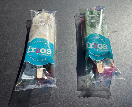Two unopened Frios Gourmet Pops, Caramel Cheesecake (left) and a Limited Edition (right).