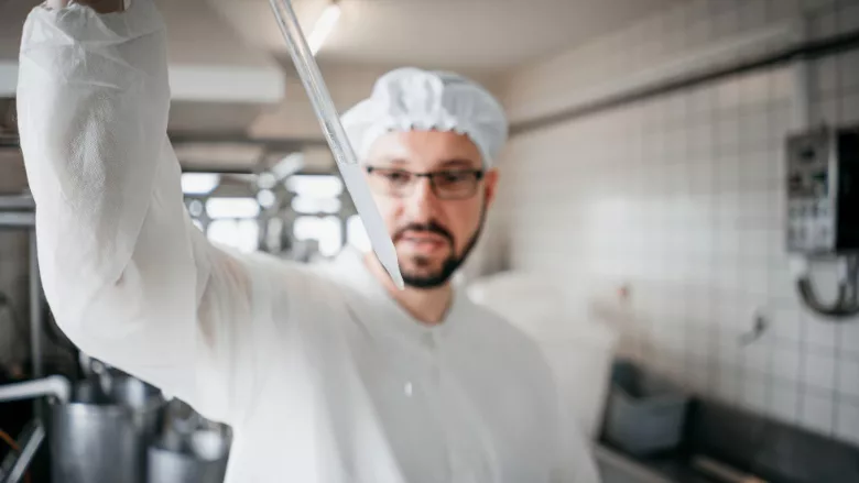 The technologist examines the quality of milk, test tubes.