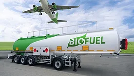 Airplane and biofuel tank trailer with a grass lawn and blue, cloudy sky as a backdrop.