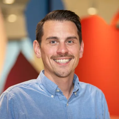 Matt Graziose 400x400 headshot with a colorful blurred background.