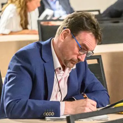 A man takes notes at Membrane Technology Forum