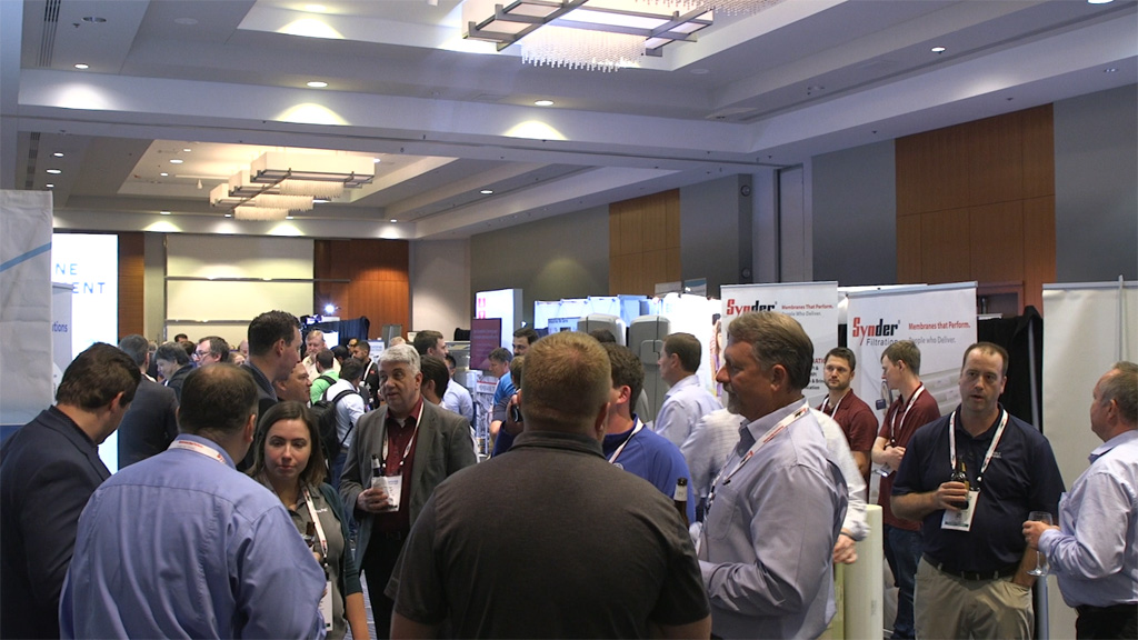 A crowd gathered near a Membrane Technology Forum Exhibitor Booth